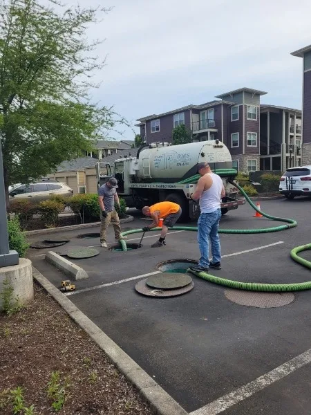 Bob's Septic Service crew pumping a commercial septic system at a multi-family property.